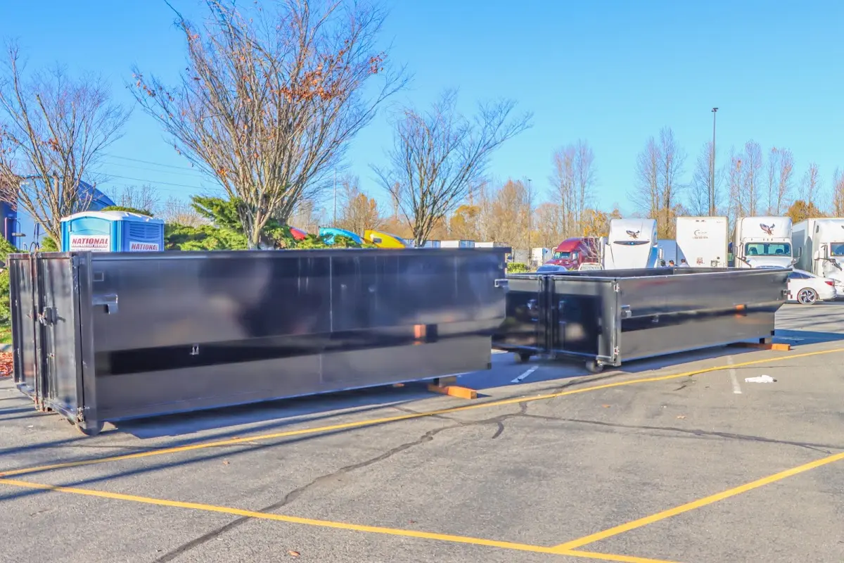 Professional dumpster rental service with roll-off container on residential driveway in Sandy Springs